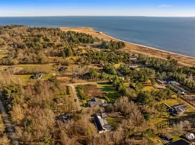 an aerial view of a home next to the ocean at Lovely Renovated Holiday Home With A Wilderness Bath And Fenced Grounds in Vesløs