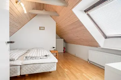 a bedroom with a bed and a vaulted ceiling at Charming Townhouse From 1877, Located In The Middle Of Løgstør Only 100 Meters From The Harbor in Løgstør