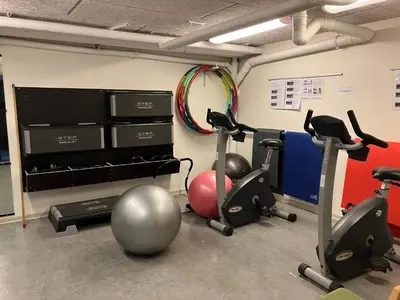 a gym with three exercise bikes in a room at Compact standard single room in Lemvig in Lemvig