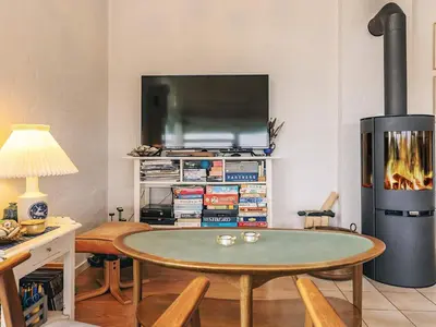 a living room with a table and a fireplace at 4 person holiday home in Struer in Struer