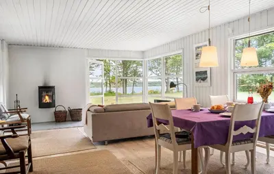 a living room with a table and a couch at Amazing Home In Roslev With Wifi in Roslev