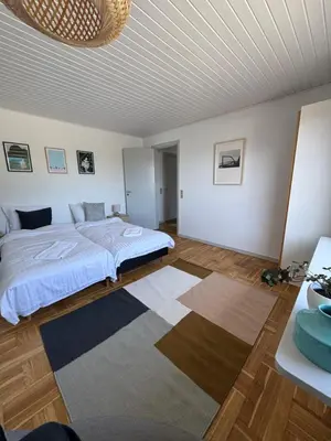 a bedroom with a bed and a rug at Viking Surf Home in Klitmøller