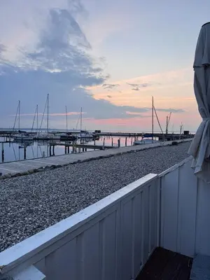 a view of a dock with boats in the water at Cozy harbor house in Nibe in Nibe