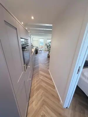 a hallway with a door and a room with a bed at Cozy harbor house in Nibe in Nibe
