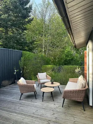 a patio with chairs and a table and a table and chairs at Sjarmerende og hyggelig lite hjem in Holstebro