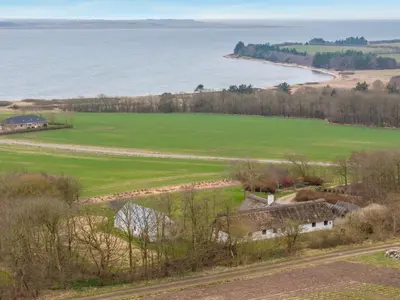 an aerial view of a field and the ocean at Holiday Home Åsta - 400m to the fjord by Interhome in Roslev