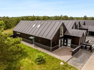an overhead view of a house with a black roof at Holiday Home Anelle - 2-5km from the sea by Interhome in Blokhus