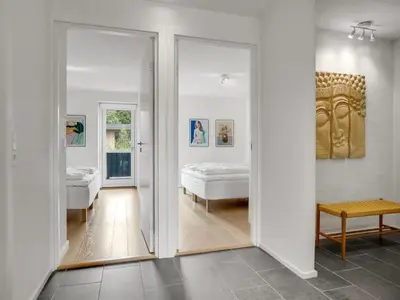 a room with two doors leading to a bedroom at Holiday Home Anelle - 2-5km from the sea by Interhome in Blokhus
