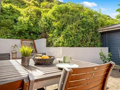 a wooden table with a bowl of fruit on a patio at Holiday Home Blia - 120m to the fjord by Interhome in Løgstør