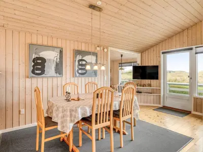 a dining room with a table and chairs at Holiday Home Fridgerd - 300m from the sea by Interhome in Løkken