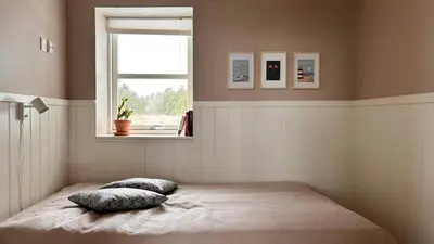a bedroom with a bed with two pillows and a window at Beautiful Home Near Løkken On Secluded Plot in Løkken