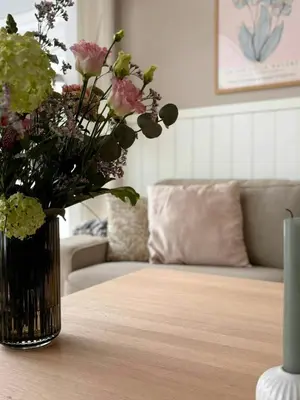 a vase of flowers sitting on a table at Beautiful Home Near Løkken On Secluded Plot in Løkken