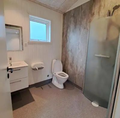 a bathroom with a toilet and a sink and a shower at Motel Glyngøre in Roslev