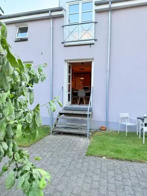 a house with a porch with a table and chairs at Cozy Pearl in Viborg Centre in Viborg