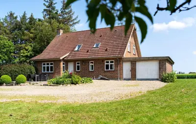 a brick house with a garage in a yard at Stunning Home In Nykøbing M With Sauna in Alsted