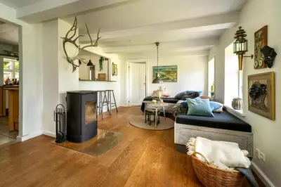 a living room with a couch and a fireplace at Country House With Fjord Views At Harre Vig in Roslev