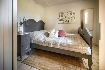 a bedroom with a bed with a dog laying on it at Country House With Fjord Views At Harre Vig in Roslev
