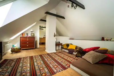 a living room with a bed and a rug at Country House With Fjord Views At Harre Vig in Roslev