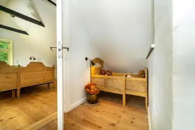 a bedroom with two bunk beds and a hallway at Country House With Fjord Views At Harre Vig in Roslev