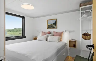 a bedroom with a large white bed with a window at 3 Bedroom Nice Home In Harboøre in Harboør