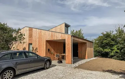 a house with a car parked in front of it at Cozy Home In Vestervig With Sauna in Vestervig