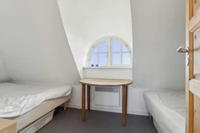 a small room with a table and a window at Thatched Holiday Home By The North Sea In Blokhus in Blokhus
