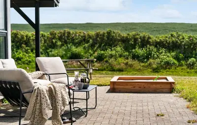 a patio with two chairs and a table and a bench at Gorgeous Home In Lemvig in Lemvig