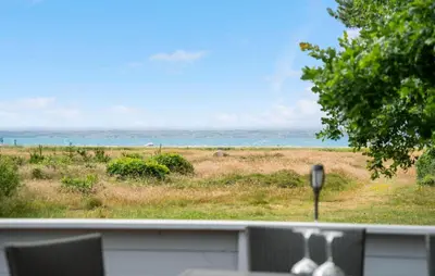 a view of a field of grass and the ocean at Stunning Home In Hurup Thy With Wifi in Sønder Ydby