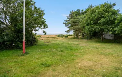 a pole in the middle of a field with trees at Stunning Home In Hurup Thy With Wifi in Sønder Ydby