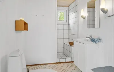 a white bathroom with a toilet and a sink at Stunning Home In Hurup Thy With Wifi in Sønder Ydby
