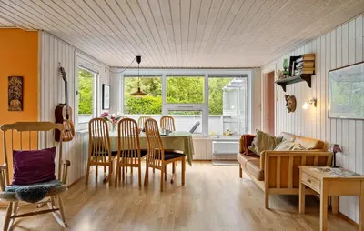 a living room with a table and a couch at Stunning Home In Hurup Thy With Wifi in Sønder Ydby