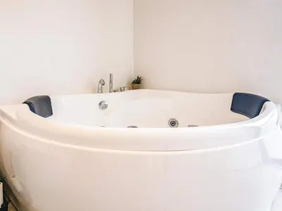 a white bath tub in a bathroom with at 5 star holiday home in Løkken in Løkken