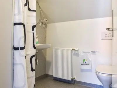 a bathroom with a toilet and a radiator at 4 star holiday home in Thyborøn in Thyborøn