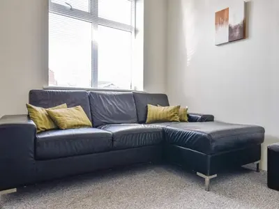 a black leather couch in a living room at 4 star holiday home in Thyborøn in Thyborøn