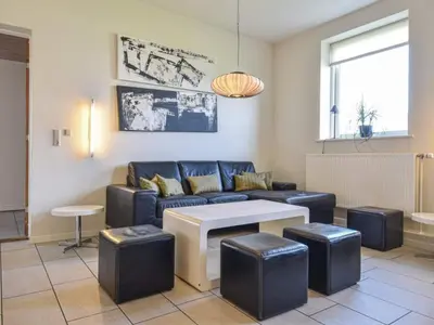 a living room with a couch and a table at 4 star holiday home in Thyborøn in Thyborøn