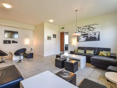a living room with a couch and a table at 4 star holiday home in Thyborøn in Thyborøn