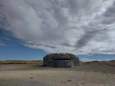 a stone structure in the desert under a cloudy sky at 4 star holiday home in Thyborøn in Thyborøn