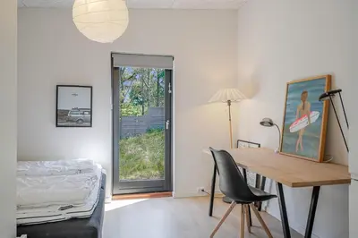 a room with a desk and a bed and a window at Lovely Holiday Home With Outdoor Sauna And Wilderness Bath, Close To Klitmøller Center And The North Sea in Torsted