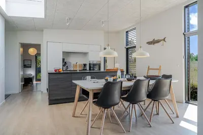 a kitchen and dining room with a table and chairs at Lovely Holiday Home With Outdoor Sauna And Wilderness Bath, Close To Klitmøller Center And The North Sea in Torsted