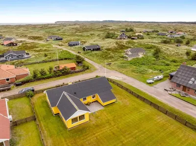 an overhead view of a home with a yellow house at Lovely Holiday Home With Fenced Plot, 300 Meters From The North Sea In Thy in Lild Strand