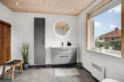 a bathroom with a sink and a mirror at Lovely Holiday Home With Fenced Plot, 300 Meters From The North Sea In Thy in Lild Strand