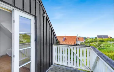 a room with a balcony with a view of a house at Holiday Home Spøttrup - 04 in Spottrup