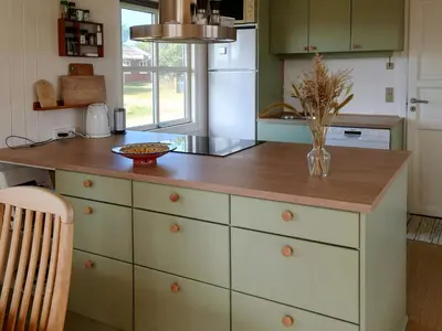 a kitchen with a counter with a vase on it at Holiday Home Overlooking Protected Dune Heath in Frøstrup