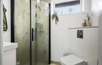 a shower with a glass door in a bathroom at Stunning Home In Blokhus With Wifi in Blokhus