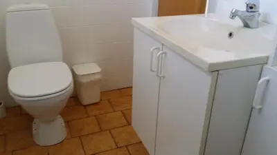 a bathroom with a white toilet and a sink at Bed & Breakfast i Vorupør in Nørre Vorupør