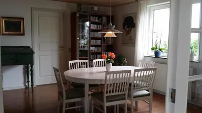 a dining room with a white table and chairs at Bed & Breakfast i Vorupør in Nørre Vorupør