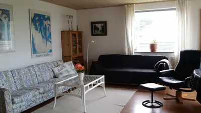 a living room with a couch and a table at Bed & Breakfast i Vorupør in Nørre Vorupør