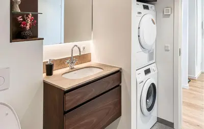 a bathroom with a sink and a washing machine at Cozy Apartment In Blokhus With Wifi in Blokhus