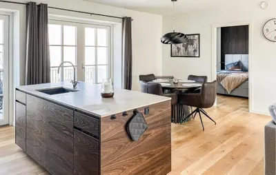 a kitchen and living room with a sink and a table at Cozy Apartment In Blokhus With Wifi in Blokhus