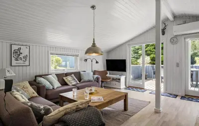 a living room with a couch and a table at 3 Bedroom Nice Home In Fjerritslev in Fjerritslev
